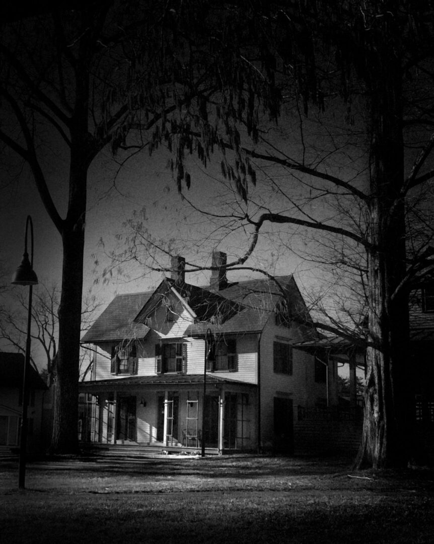 A black and white photo of an old house