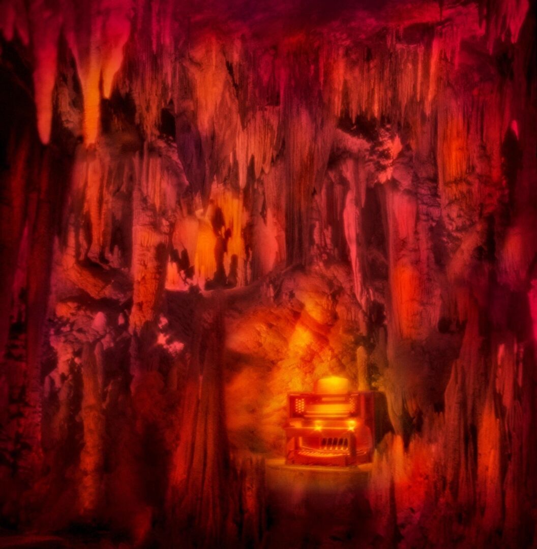 A painting of a cave with a fire in it