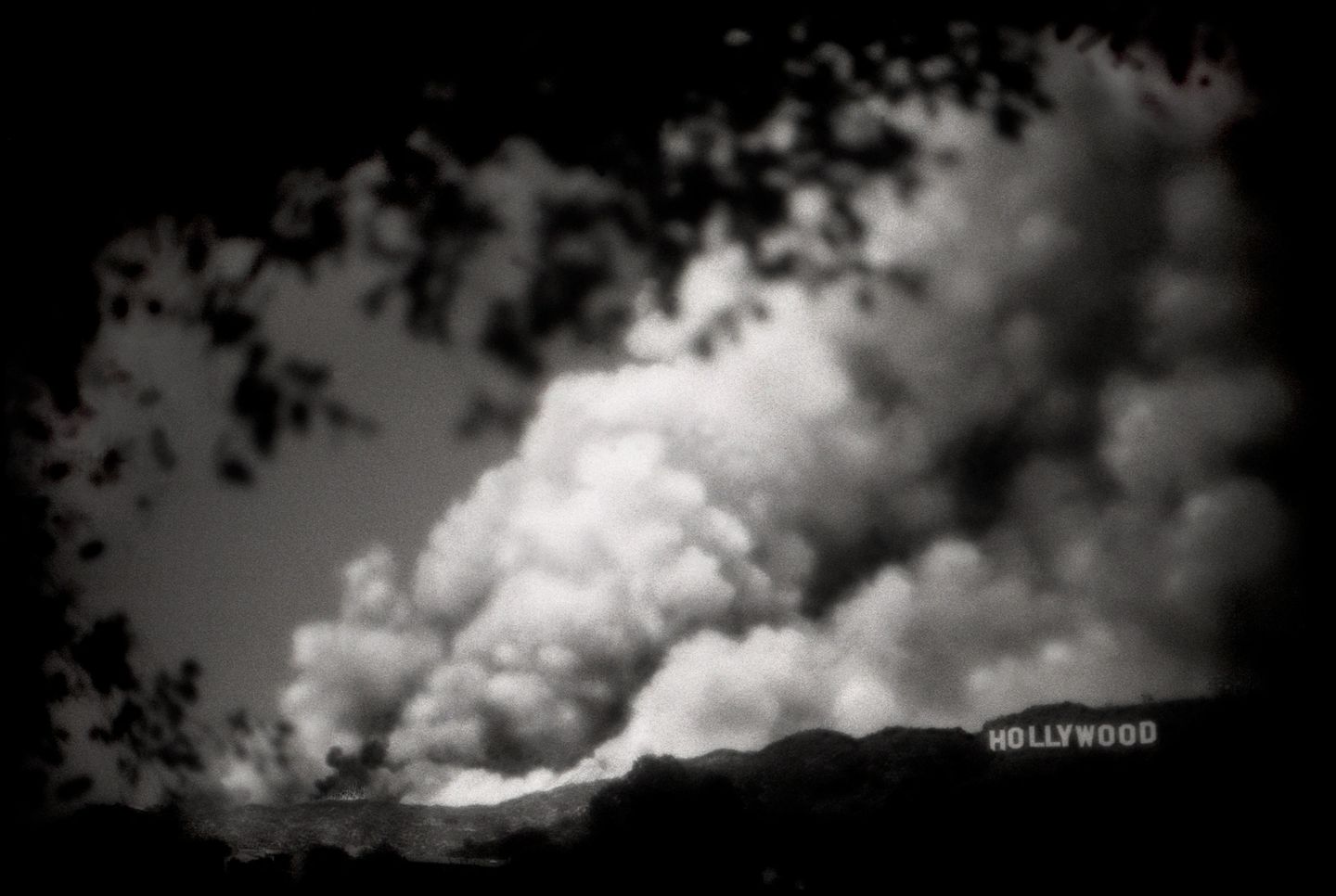 A black and white photo of smoke billowing from the sky.
