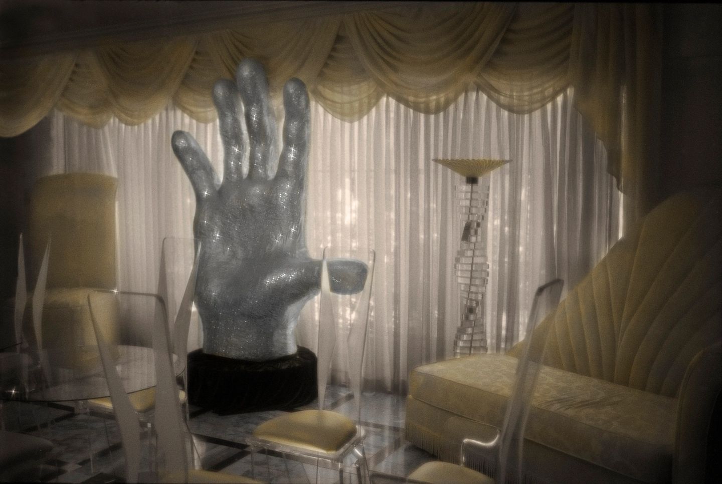 A large hand sculpture in the middle of a room.