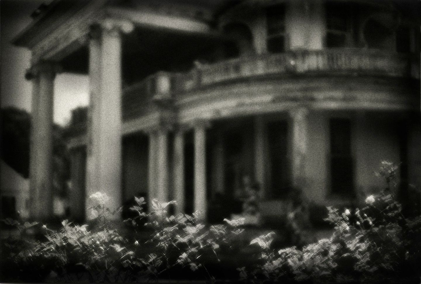 A black and white photo of an old house.