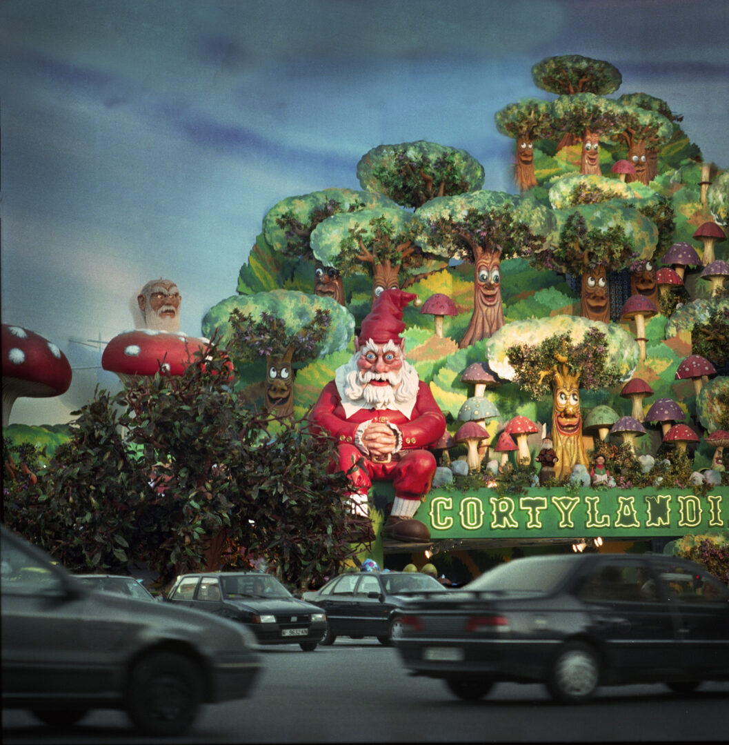 A large christmas parade float is shown in motion.